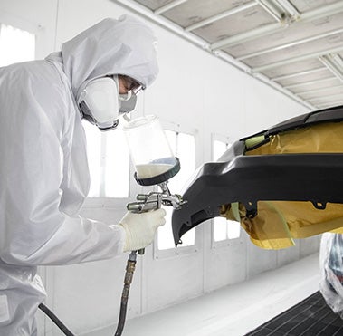 Collision Center Technician Painting a Vehicle | Toyota of Warren in Warren OH